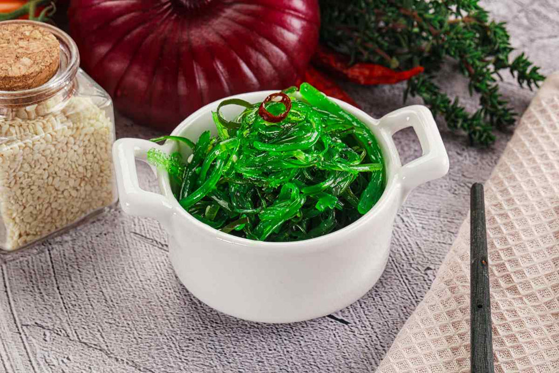 A bowl of seaweed with vegetables and spices
