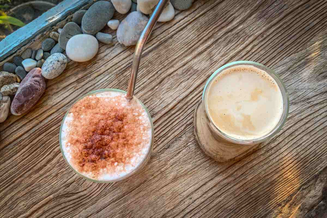 Iced cappuccino and hot coffee with some stone decorations on brown table