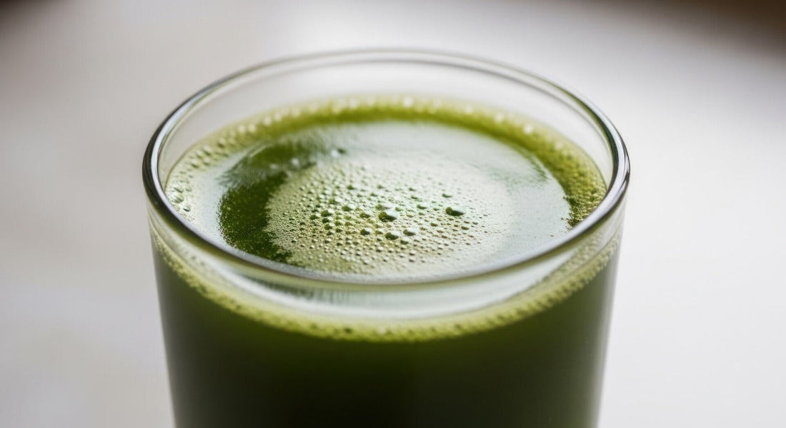A glass of sea moss juice sitting on a table