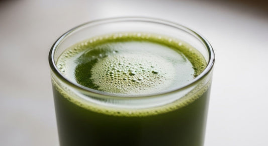 A glass of sea moss juice sitting on a table