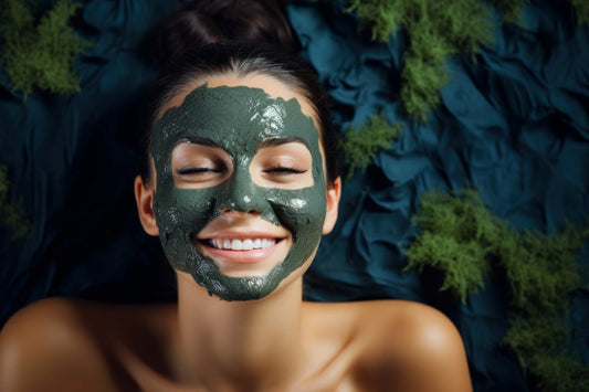 brunette woman with blue eyes enjoying a seaweed facial mask for skin hydration relaxing spa background with empty space for text